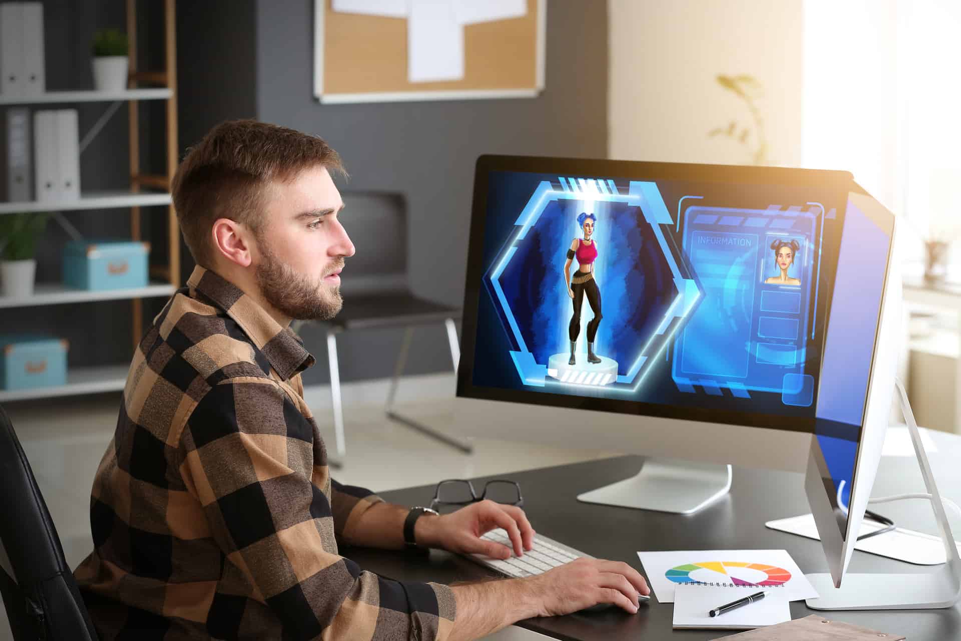 A person works at a computer, creating a digital character on the screen. The room has shelves, a chair, and a window. Text on the screen reads "INFORMATION."